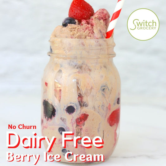 Dairy Free Berry Ice Cream in a jar with a straw and strawberry on top